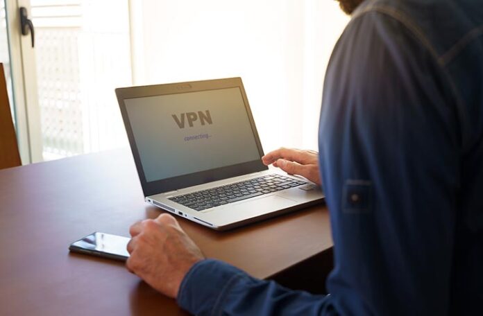 Man,Working,From,Home,And,Worried,About,Covid-19,,Coronavirus,,Keeping Laptop screen with VPN connecting shown