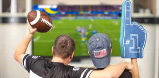 A father and son watching the Super Bowl on TV at home.