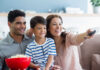 A father, mother, and son getting ready to stream a new TV series at home.